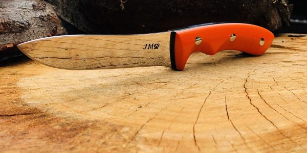 pro hunter custom made hunting knife displayed on wood board